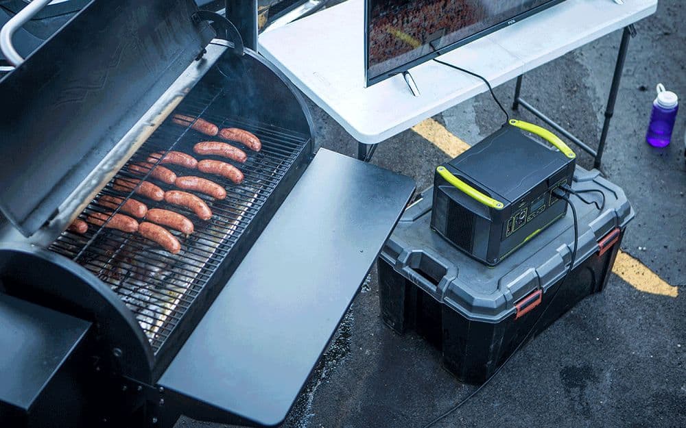 A portable power source is essential for using your pellet grill on the road, like this tailgating setup.